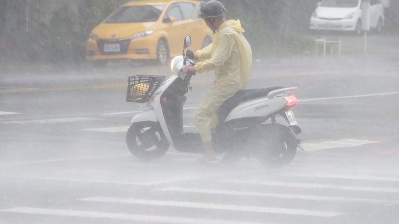 A man struggles in the heavy wind and rain generated by Typhoon Krathon in Kaohsiung, southern Taiwan, Thursday, Oct. 3, 2024. (AP Photo/Chiang Ying-ying)