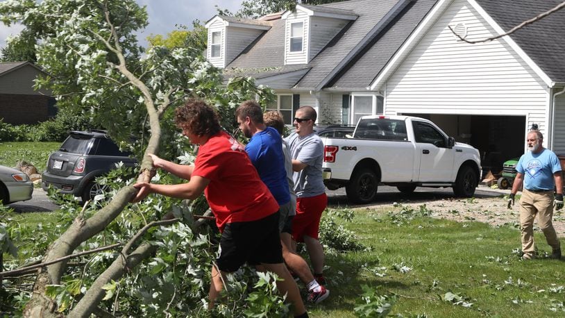 Members of the Northwestern High School football team volunteered to help clean up Thursday, june 9, 2022, after Wednesday’s storm caused extensive damage in German Twp. An EF1 tornado touched down north of Springfield. BILL LACKEY/STAFF