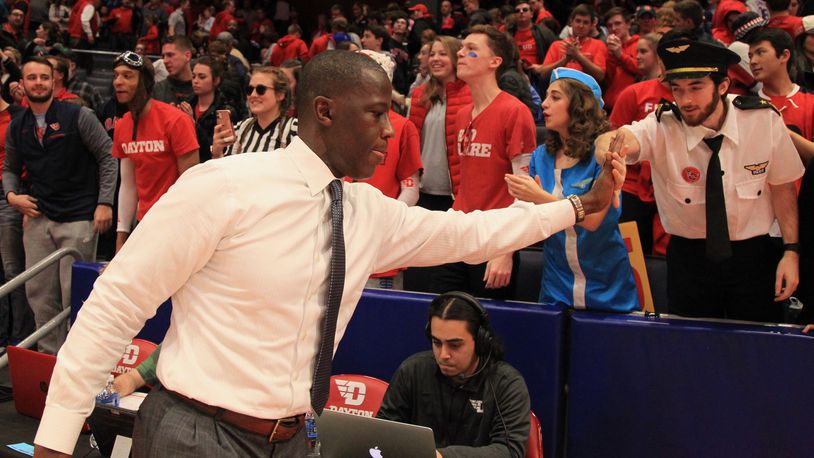 Dayton’s Anthony Grant slaps hands with fans after a game against Duquesne on Saturday, Feb. 22, 2020, at UD Arena. David Jablonski/Staff