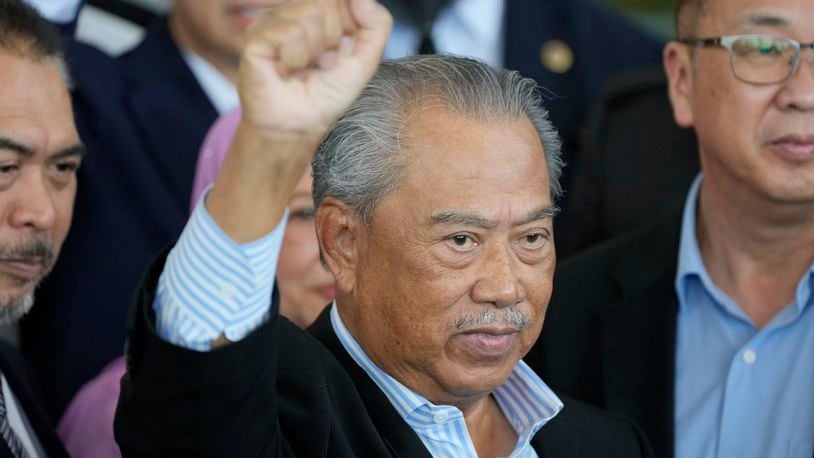 FILE - Malaysia's former Prime Minister Muhyiddin Yassin poses for media outside courthouse, after charged with corruption and money laundering, in Kuala Lumpur, Malaysia, on March 10, 2023. (AP Photo/Vincent Thian, File)