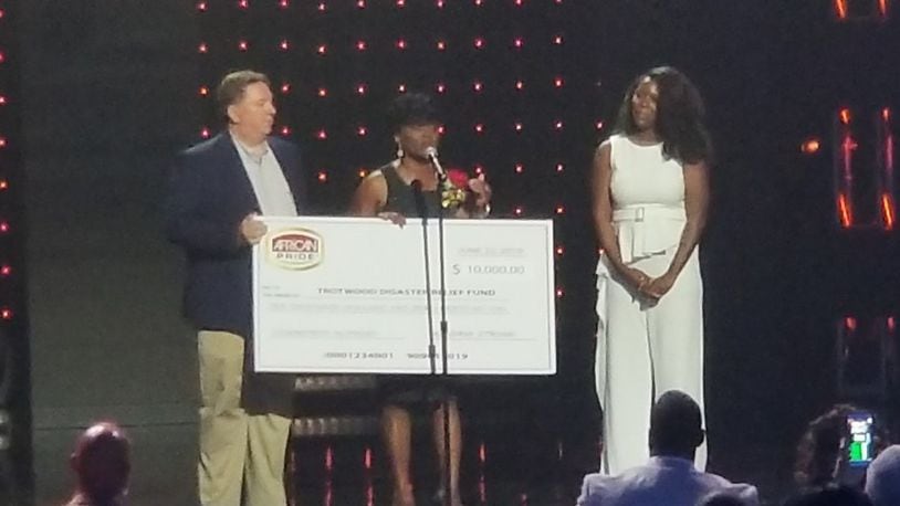 Trotwood Mayor Mary McDonald and attorney Jeff Rezabek, who is the Trotwood Disaster Relief chair, were presented a check of $10,000 from African Pride at Gospel Superfest last weekend. CONTRIBUTED