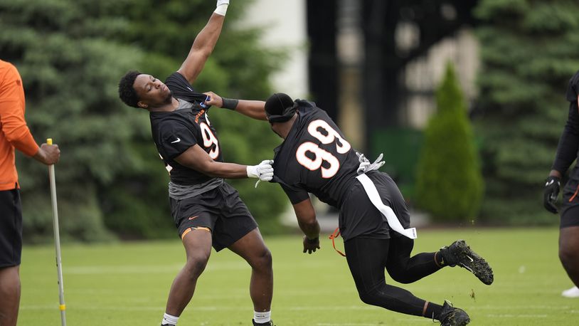 Cincinnati Bengals defensive ends Jeff Gunter (93) and Myles Murphy (99) work drills during the NFL football team's practice on Tuesday, May 14, 2024, in Cincinnati. (AP Photo/Carolyn Kaster)