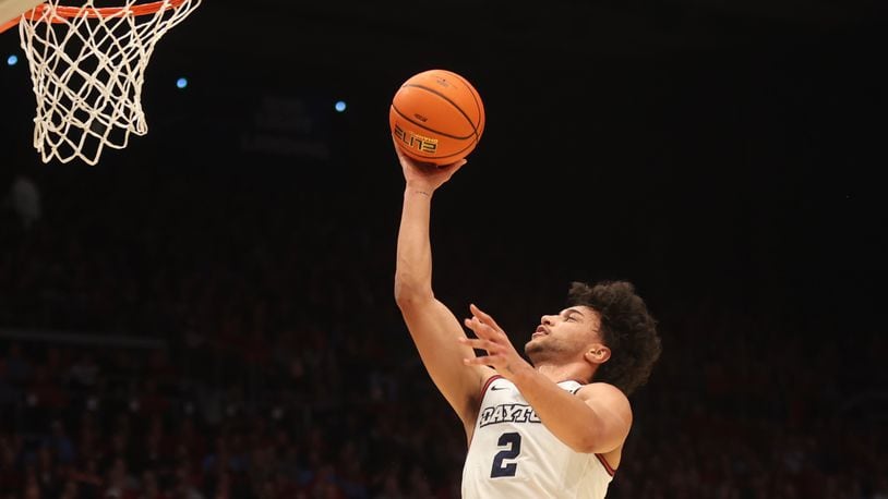 Dayton's Nate Santos scores against George Washington on Tuesday, Jan. 30, 2024, at UD Arena. David Jablonski/Staff