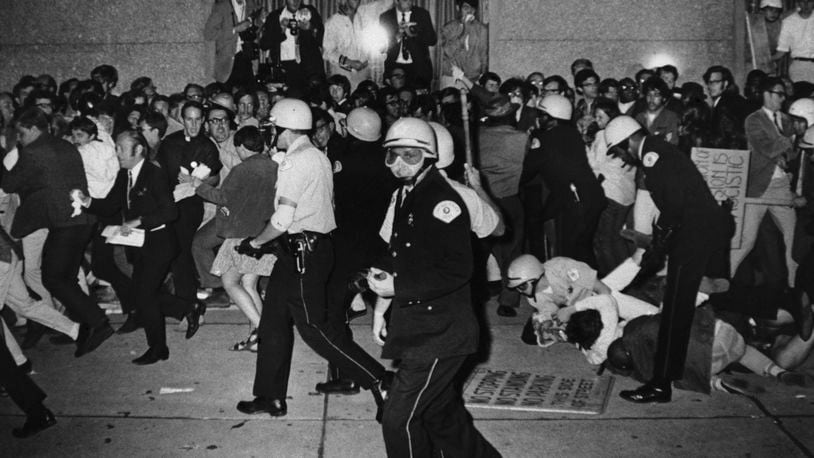 FILE - Chicago Police attempt to disperse demonstrators outside the Conrad Hilton, Democratic National Convention headquarters, Aug. 29, 1968, in Chicago. (AP Photo/Michael Boyer, File)