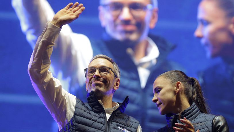 Head of the Freedom Party (FPOE) Herbert Kickl, left, waves to supporters besides party colleague Susanne Fuerst after his speech at a final election campaign event at St. Stephen's square in Vienna, Austria, Friday, Sept. 27, 2024, ahead of the country's national election which will take place on Sept. 29. (AP Photo/Heinz-Peter Bader)