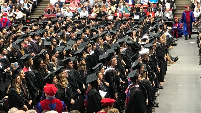Undergraduate students receive their diplomas at the University of Dayton’s large commencement ceremony. FILE PHOTO