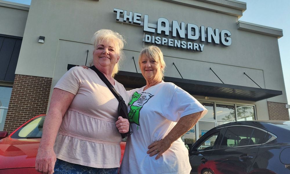 Becky Vliege, left, and Carey Farmer, from Liberty Twp. sat in their car as the first to arrive at The Landing Dispensary in Monroe on Tuesday, Aug. 6, 2024. NICK GRAHAM / STAFF