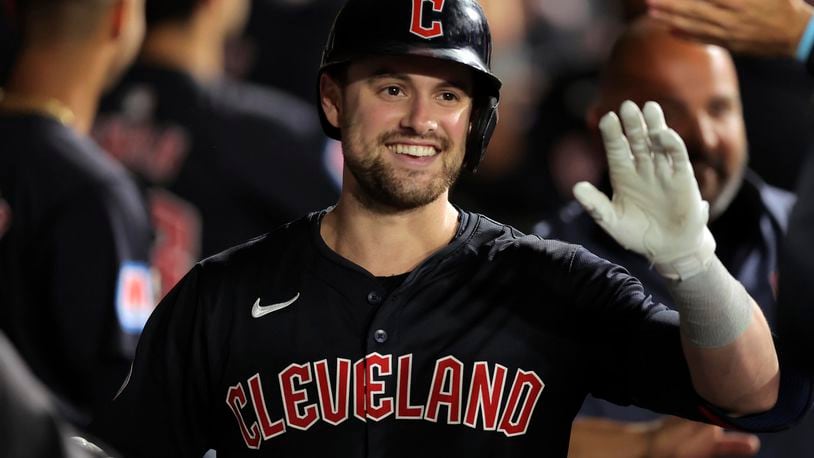 Cleveland Guardians' Lane Thomas celebrates in the dugout after hitting a three-run home run during the sixth inning of a baseball game against the Chicago White Sox Tuesday, Sept. 10, 2024, in Chicago. (AP Photo/Melissa Tamez)