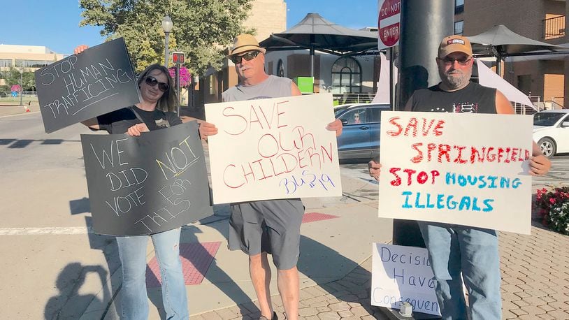 Pictured (L to R) are Melissa and Jay Durst and a man who wished not to be identified who joined other Springfield residents expressing frustration following a fatal school bus accident that resulted in vehicular homicide charges against Haitian immigrant Hemanio Joseph. Citizens demanded action from city officials, who say they have a limited role in addressing immigrant issues. CONTRIBUTED BY VICKY FORREST