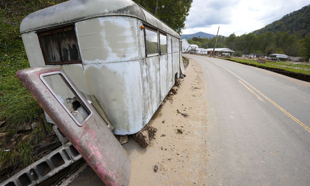 A trailer moved by floodwater sits on the side of a road in the aftermath of Hurricane Helene, Thursday, Oct. 3, 2024, in Pensacola, N.C. (AP Photo/Mike Stewart)