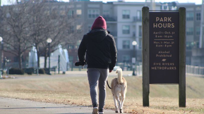 A man and his dog out for a walk at Deeds Point MetroPark on Friday. CORNELIUS FROLIK / STAFF
