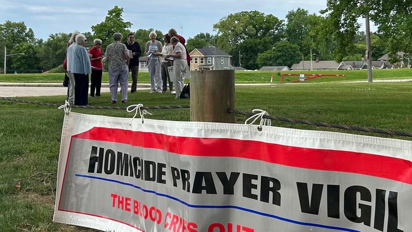 A group of Dayton-area residents hold a prayer vigil for homicide victims June 8, 2024, at McIntosh/Riverview Park in Dayton. JEREMY P. KELLEY / STAFF