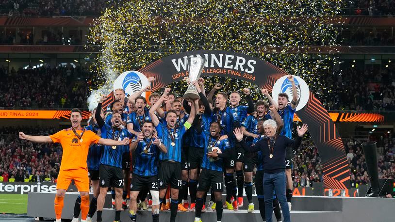 Atalanta's players celebrate with the trophy after winning the Europa League final soccer match between Atalanta and Bayer Leverkusen at the Aviva Stadium in Dublin, Ireland, Wednesday, May 22, 2024. (AP Photo/Kirsty Wigglesworth)