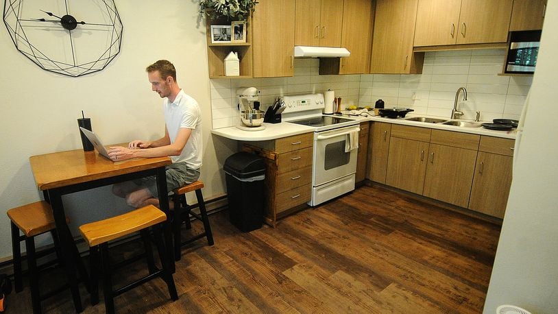 Joseph Tyre works in his kitchen at his apartment in Miamisburg on Friday, July 28, 2023. Tyre and his wife saved to buy a home, but now are waiting for the housing market to calm down. MARSHALL GORBY\STAFF