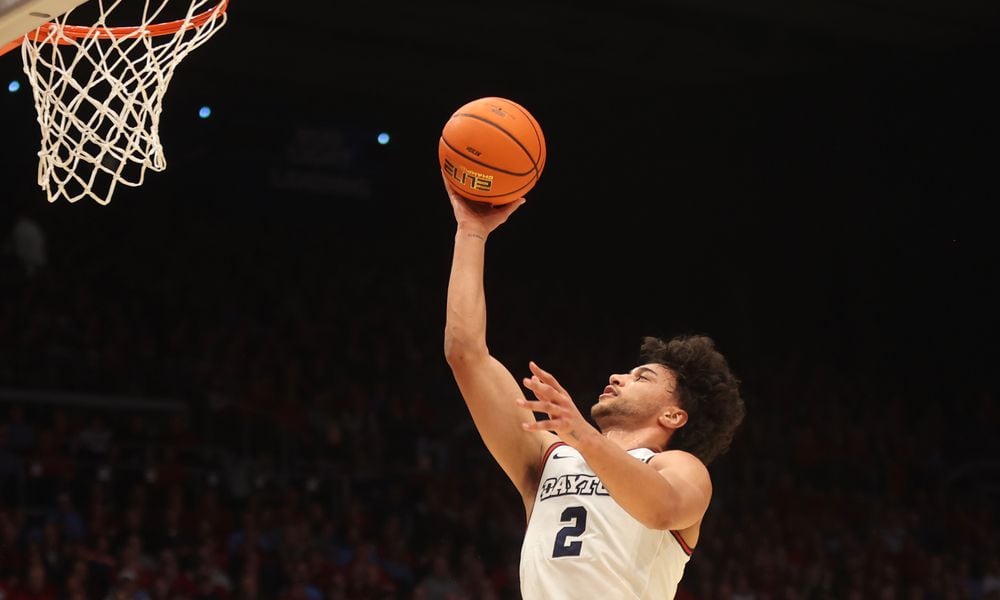 Dayton's Nate Santos scores against George Washington on Tuesday, Jan. 30, 2024, at UD Arena. David Jablonski/Staff