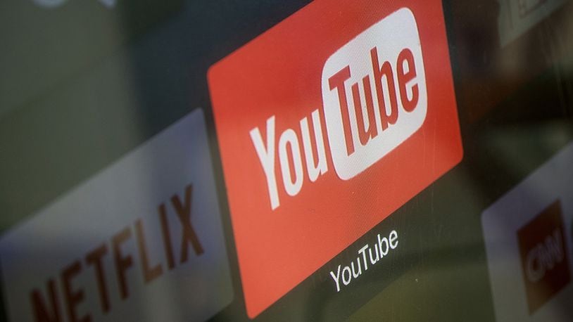 The YouTube and Netflix app logos are seen on a television screen. Deadline reported that a horror film based on the "Momo challenge" internet hoax that reprtedly emerged on YouTube last year is in the works.