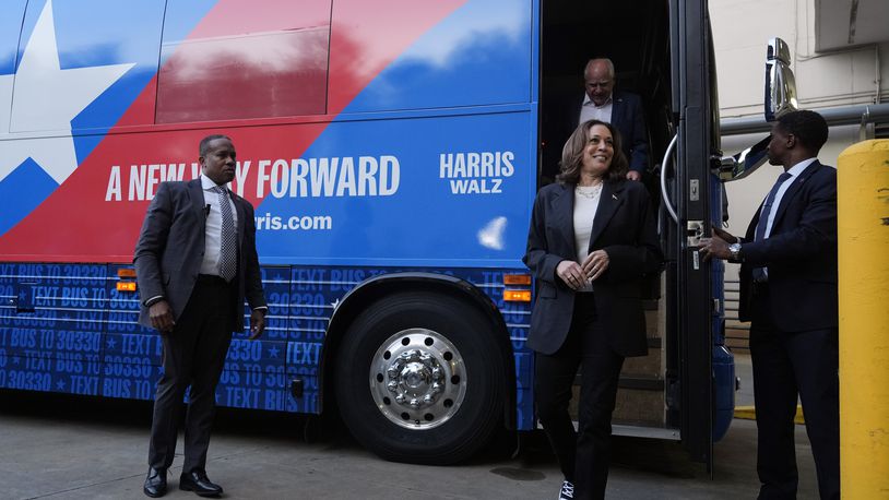 Democratic presidential nominee Vice President Kamala Harris and her running mate Minnesota Gov. Tim Walz exit their campaign bus in Savannah, Ga., Wednesday, Aug. 28, 2024. (AP Photo/Jacquelyn Martin)