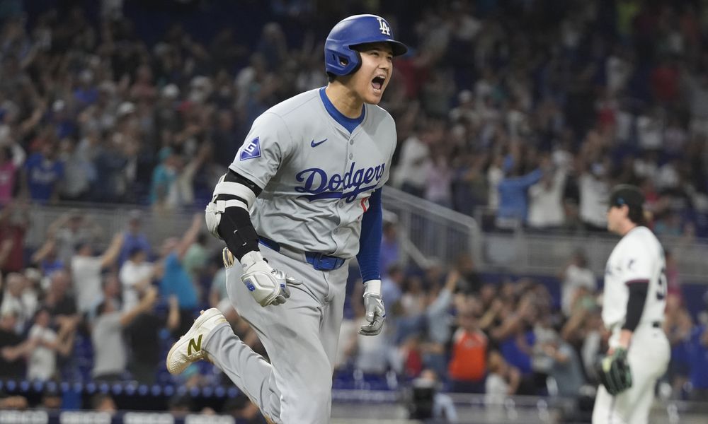 Los Angeles Dodgers' Shohei Ohtani (17) reacts after hitting his 50th home run of the season during the seventh inning of a baseball game against the Miami Marlins, Thursday, Sept. 19, 2024, in Miami. (AP Photo/Marta Lavandier)