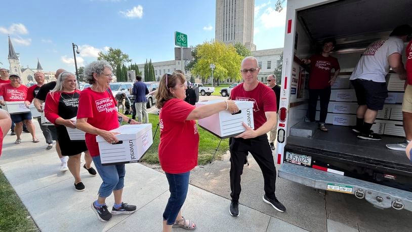 FILE - Organizers load boxes of signed petitions seeking to get a measure on the November ballot that would repeal a new Nebraska law providing taxpayer money for private school tuition, July 17, 2024, in Lincoln, Neb. (AP Photo/Margery Beck, File)