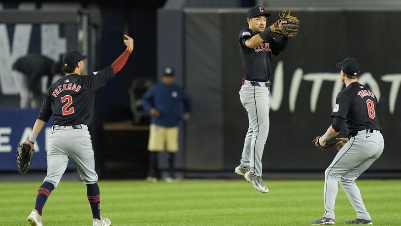 Cleveland Guardians outfielders Tyler Freeman, left, Steven Kwan, center, and Lane Thomas celebrate after a baseball game against the New York Yankees at Yankee Stadium Tuesday, Aug. 20, 2024, in New York. The Guardians defeated the Yankees in extra innings 9-5.(AP Photo/Seth Wenig)