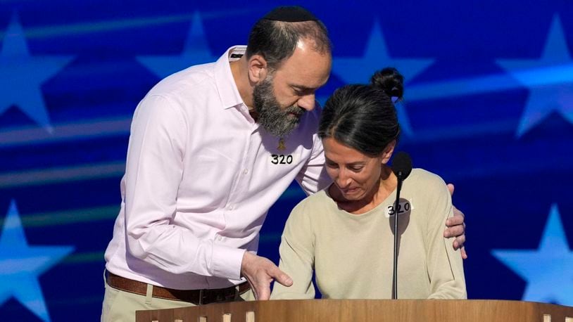 Jon Polin, left, and Rachel Goldberg, parents of Hersh Goldberg-Polin, speak on stage during the Democratic National Convention Wednesday, Aug. 21, 2024, in Chicago. (AP Photo/J. Scott Applewhite)