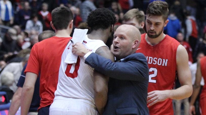 Davidson’s Kevin Kuwik hugs Dayton’s Josh Cunningham after a game on Tuesday, Jan. 23, 2018, at UD Arena. David Jablonski/Staff