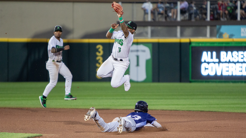 Dayton second baseman Victor Acosta pulls down a high throw from catcher Connor Burns as West Michigan's Johnny Peck steals second base Tuesday night at Day Air Ballpark. Jeff Gilbert/CONTRIBUTED