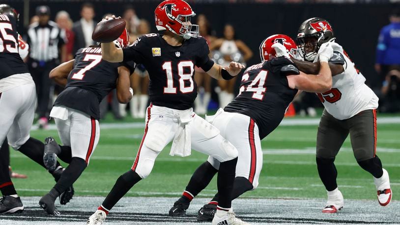 Atlanta Falcons quarterback Kirk Cousins (18) throws the game-wining touchdown pass to wide receiver KhaDarel Hodge (12) against the Tampa Bay Buccaneers during overtime in an NFL football game Thursday, Oct. 3, 2024, in Atlanta. (AP Photo/Butch Dill)