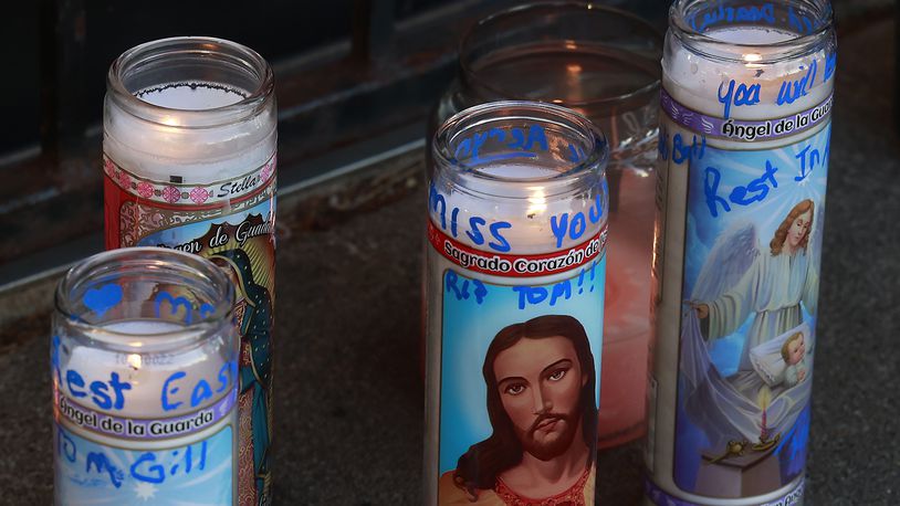 Family, friends and community members filled the parking lot of Gill's Quality Meat Market Monday, Jan. 9, 2023 during a candle light vigil for Thomas Gill, who was shot and killed while driving his SUV in Springfield. BILL LACKEY/STAFF