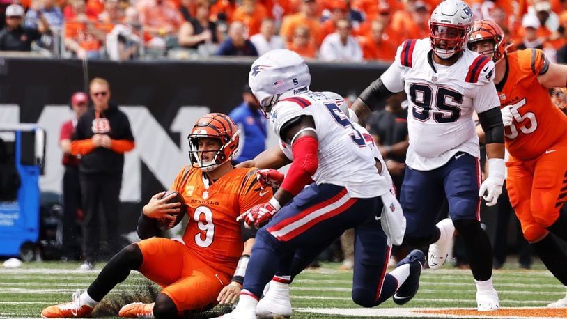 Bengals quarterback Joe Burrow slides during Sunday's season opener vs.the Patriots at Paycor Stadium. The Patriots won 16-10. Nick Graham/STAFF