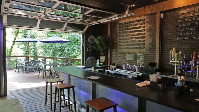 The rear patio and bar at the former 316 Tap & Barrel Grill in Medway. The Mad River Tavern will open under owners Dustin and Tiffany Gilroy, offering locally sourced American pub fare, some comfort food and fried pizza, which they enjoyed while living in Italy. BILL LACKEY/STAFF