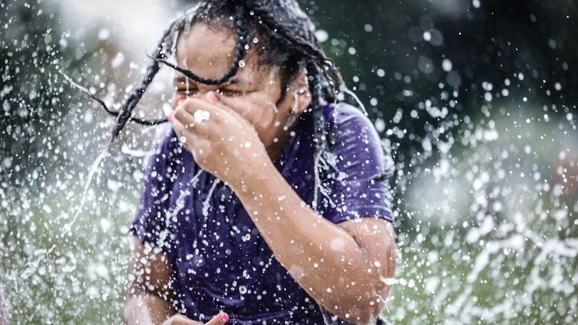 Sirius Sol Mathews, from Dayton, enjoys the splash pad at W.S. Mcintosh Park in Dayton. Temperatures are expected to reach the 90s this week. JIM NOELKER/STAFF