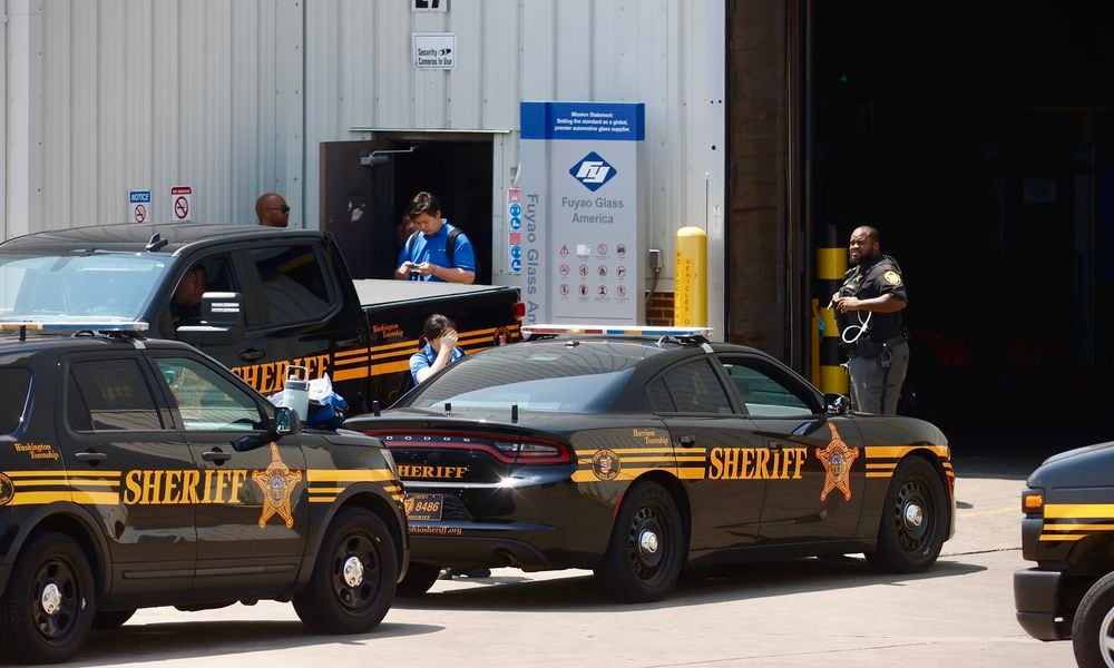 Several Montgomery County Sheriff's Office cruisers were staged outside Fuyao Glass America in Moraine Friday, July 26, 2024. MARSHALL GORBY \STAFF