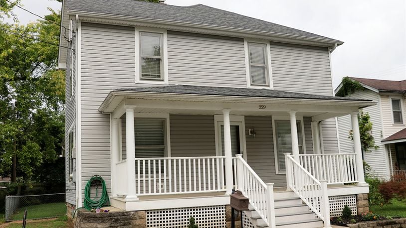 Exterior updates to the roof, gutters and siding were made in 2012 with the porch getting a white vinyl railing, composite wood steps and painted support columns. Some of the wood-pane windows have storm windows and the front door has the original door bell. The house has several garden beds, a fenced back yard with oversized gate, and a semi-private back yard with storage shed. Inside, the updated kitchen has granite countertops including an island and a butler’s pantry with the original cabinetry. Kathy Tyler/CONTRIBUTED