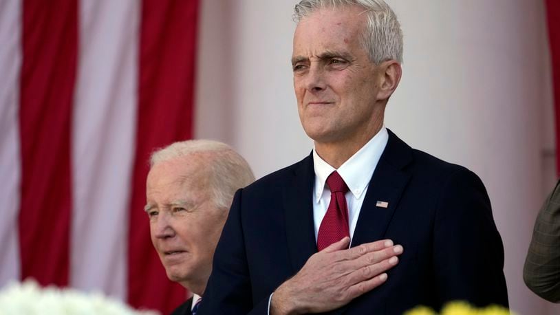 Veterans Affairs Secretary Denis McDonough watches as President Joe Biden arrives to speak at the National Veterans Day Observance at the Memorial Amphitheater at Arlington National Cemetery in Arlington, Va., Saturday, Nov. 11, 2023. (AP Photo/Andrew Harnik)