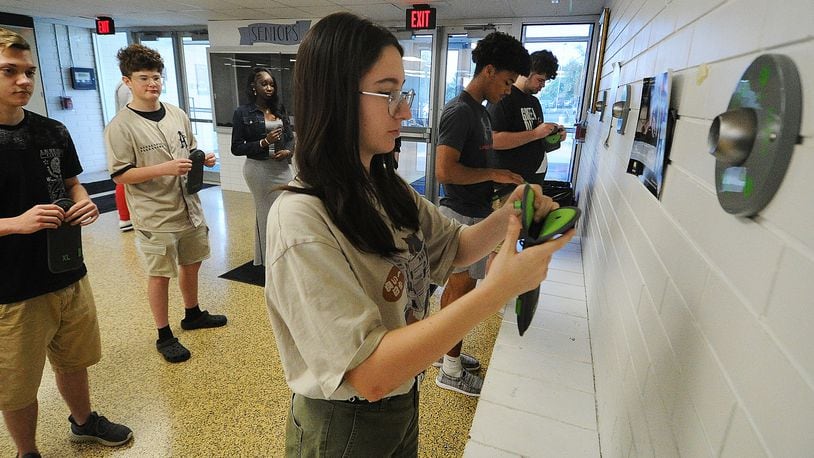 Fairborn High School students place their cell phones into pouches Thursday, May 23, 2024. Front row, left to right, Isabelle Fischer, Andrew Wilson and Travis Butts, back row from left Shane Walden, Clayton Finlay and Aita Samb. MARSHALL GORBY\STAFF