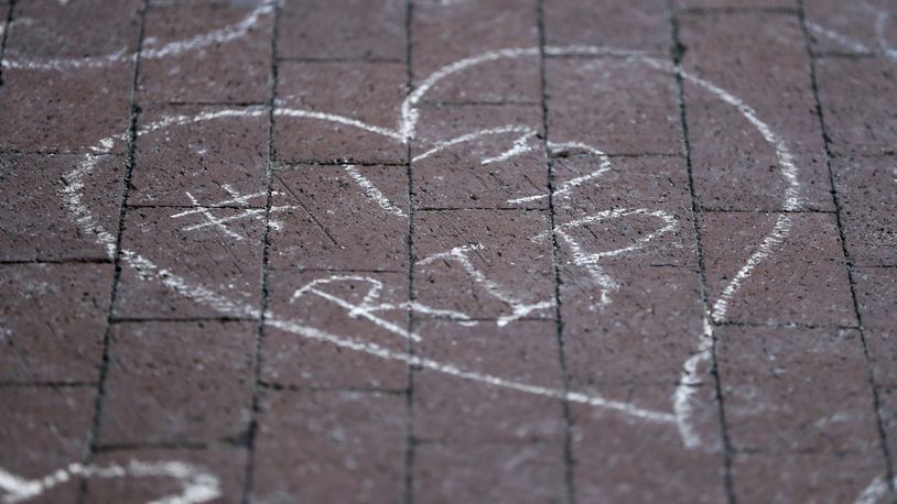 Columbus Blue Jackets fans leave chalk messages during the candlelight vigil to honor Blue Jackets hockey player Johnny Gaudreau, Thursday, Sept. 4, 2024, outside of Nationwide Arena in Columbus, Ohio. Gaudreau and his brother Matthew were killed by a motor vehicle last week while riding bicycles. (AP Photo/Joe Maiorana)