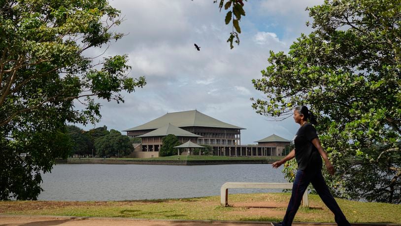 A woman walks outside parliamentary complex in Colombo, Sri Lanka, Wednesday, Sept. 25, 2024. (AP Photo/Eranga Jayawardena)