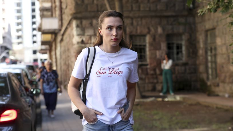 Dziana Maiseyenka, 28, walks in a street in Yerevan, Armenia, Saturday, Sept. 7, 2024, after being denied entry to neighboring Georgia because an arrest warrant had been issued for her by authorities in Minsk. (Hayk Baghdasaryan/Photolurey via AP)