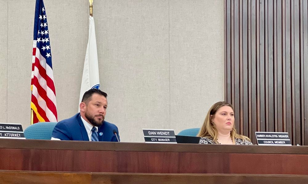 Vandalia City Manager Dan Wendt, left, listens as residents address council as part of a public comment segment during a special meeting held Wednesday. AIMEE HANCOCK/STAFF