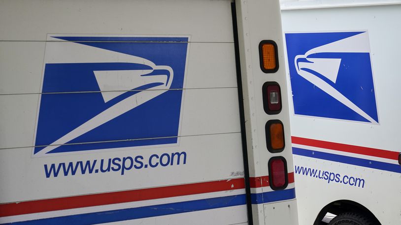 FILE - U.S. Postal Service delivery vehicles are parked outside a post office in Boys Town, Neb., Aug. 18, 2020. (AP Photo/Nati Harnik, File)