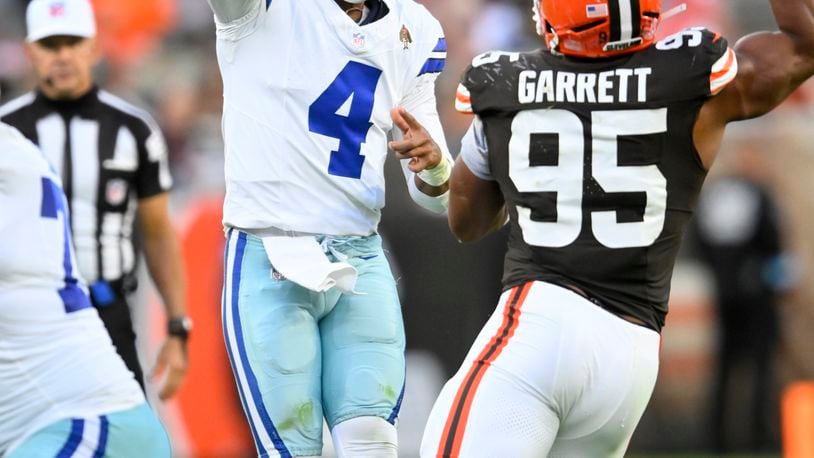 Dallas Cowboys quarterback Dak Prescott (4) throws a pass as Cleveland Browns defensive end Myles Garrett (95) rushes in the second half of an NFL football game in Cleveland, Sunday, Sept. 8, 2024. (AP Photo/David Richard)