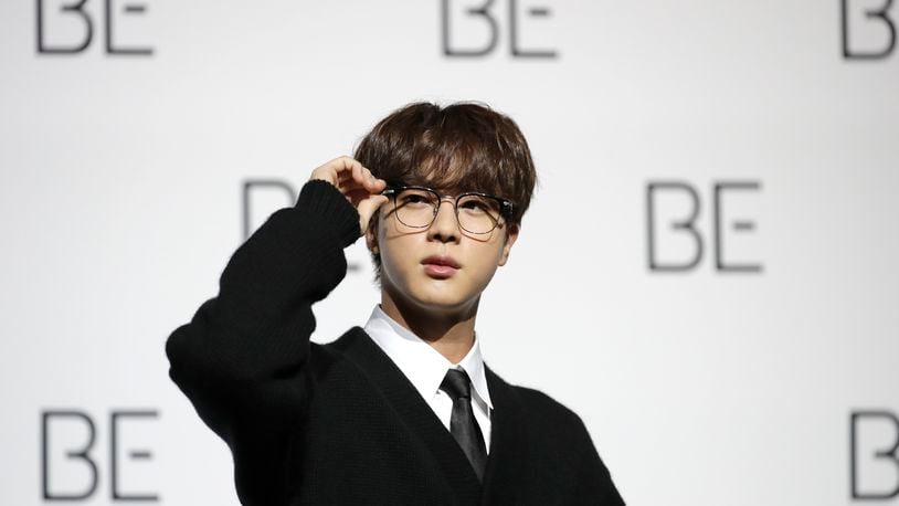 FILE - Jin, a member of South Korean K-pop band BTS, poses for photographers during a press conference to introduce their new album "BE" in Seoul, South Korea, Friday, Nov. 20, 2020. Jin, the oldest member of K-pop supergroup BTS, will make a mark in the Paris Olympics as a torchbearer from South after recently returning from his mandatory military service. (AP Photo/Lee Jin-man, File)