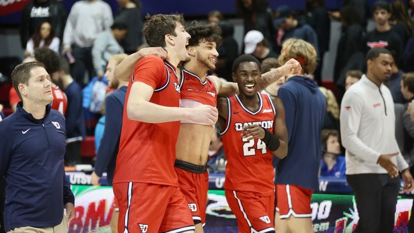 Dayton's Isaac Jack, Nate Santos and Koby Brea leave the court after a victory against Southern Methodist on Wednesday, Nov. 29, 2023, at Moody Coliseum in Dallas, Texas. David Jablonski/Staff