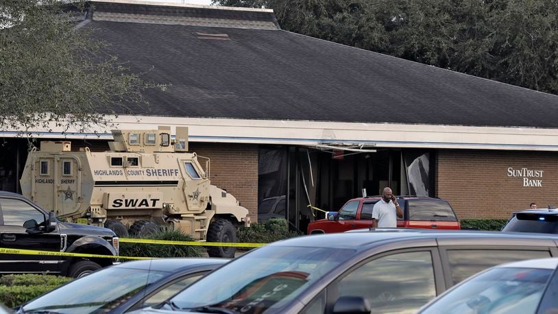 FILE - A Highlands County Sheriff's SWAT vehicle is stationed out in front of a SunTrust Bank branch, Wednesday, Jan. 23, 2019, in Sebring, Fla., where authorities say five people were shot and killed. Assistant State Attorney Bonde Johnson told jurors during closing arguments Wednesday, June 26, 2024, that Xaver, 27, committed the murders at Sebring's SunTrust bank in Florida in 2019, to satisfy his yearslong desire to experience killing, forcing the women to lie down before executing them. (AP Photo/Chris O'Meara, File)