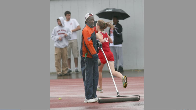 Andre Owings tries to keep the water at bay as the meet continues in the rain during the Don Mitchell Roosevelt Memorial Track and Field Meet at UD's Welcome Stadium on May 2, 2008.  Photo by E.L. Hubbard