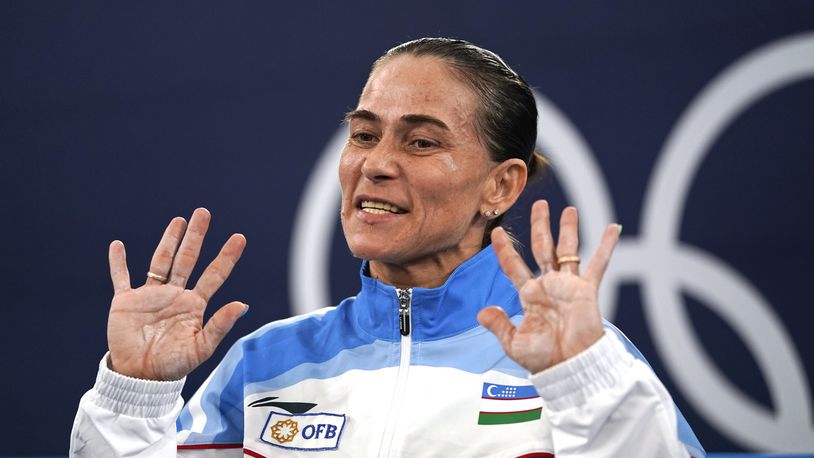 FILE - Oksana Chusovitina of Uzbekistan gestures after performing on the vault during the women's artistic gymnastic qualifications, her eighth Olympics participation, at the 2020 Summer Olympics in Tokyo, on July 25, 2021. Record-breaking 48-year-old gymnast Oksana Chusovitina says an injury has ended her attempt to qualify for what would have been her ninth Olympics. (AP Photo/Ashley Landis, File)