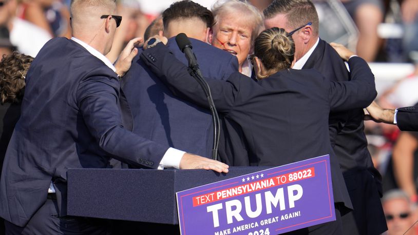 FILE - Republican presidential candidate former President Donald Trump is surrounded by Secret Service at a campaign event in Butler, Pa., July 13, 2024. Few Americans have high confidence in the Secret Service's ability to keep presidential candidates safe after last month's attempt on Trump's life. That is according to a new poll conducted July 25-29, 2024, from the AP-NORC Center for Public Affairs Research. Only around three in 10 Americans are extremely or very confident that the Secret Service can keep the presidential candidates safe from violence before the election. (AP Photo/Gene J. Puskar, File)