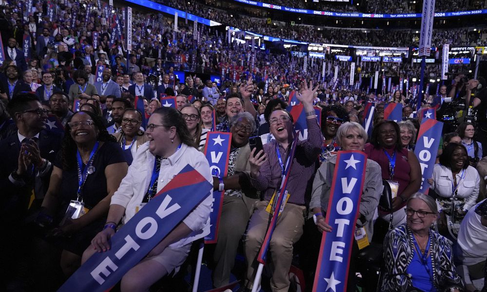 Delegates watch as former President Barack Obama speaks during the Democratic National Convention Tuesday, Aug. 20, 2024, in Chicago. (AP Photo/Brynn Anderson)