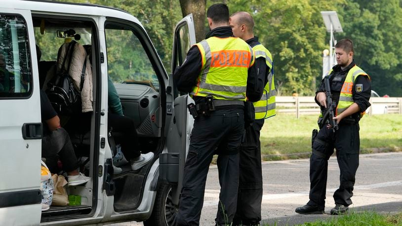 German police check the details of a van from Bulgaria near the border to Belgium in Aachen, Germany, Monday, Sept. 16, 2024, as Germany begins carrying out checks at all its land borders. (AP Photo/Martin Meissner)